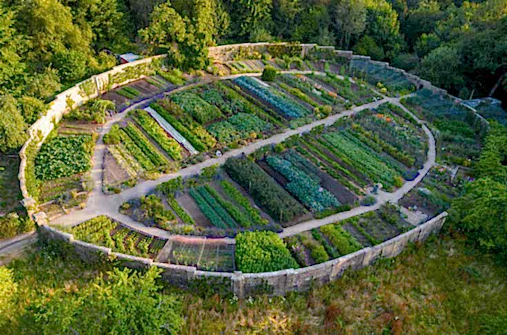 Aerial view of Gravetye Manor in West Sussex, showcasing the historic country hotel and its renowned kitchen garden.