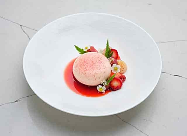 Baked cheesecake with fruit compote and crisp crumb. Dessert from Gravetye Manor restaurant West Sussex.