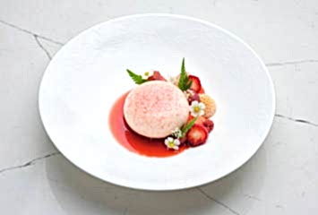 Baked cheesecake with fruit compote and crisp crumb. Dessert from Gravetye Manor restaurant West Sussex.